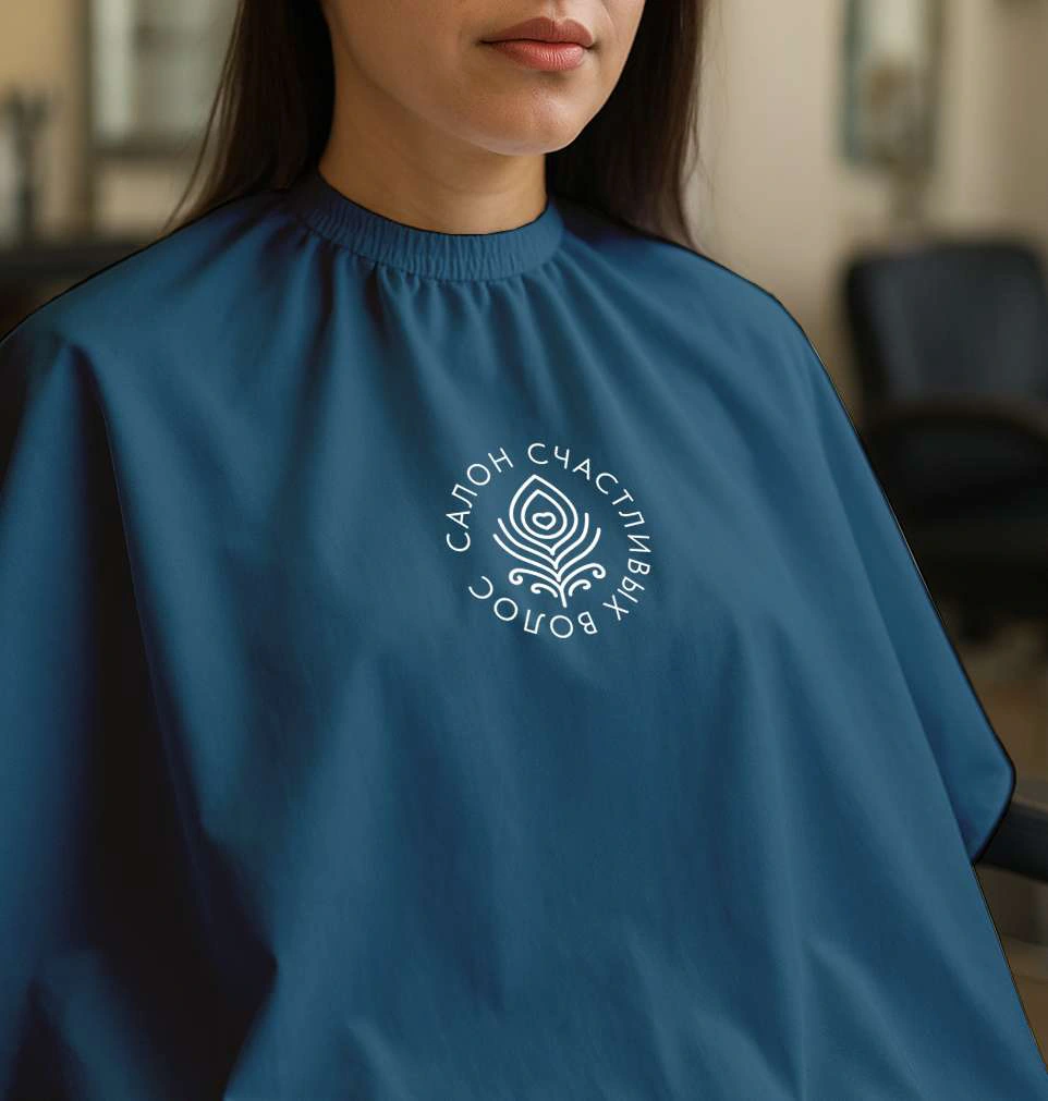 The salon cape / The circular signature in use.
